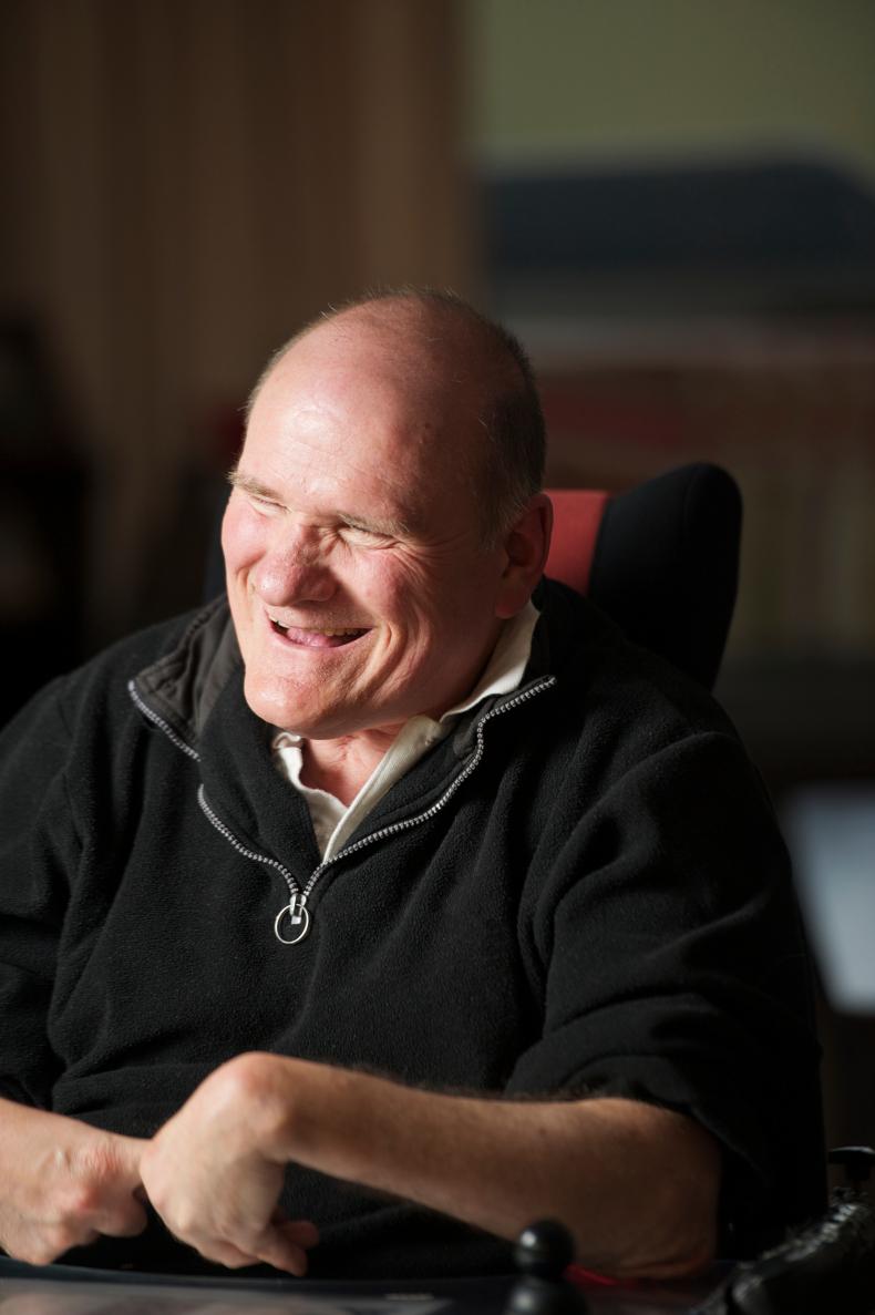 Man in an electric wheelchair laughing