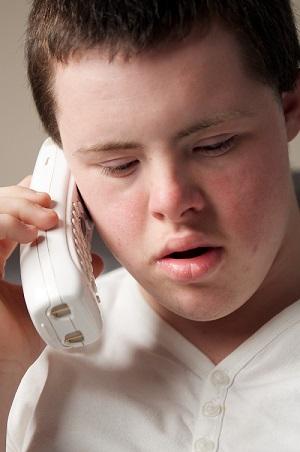 Sixteen year old boy talking on telephone
